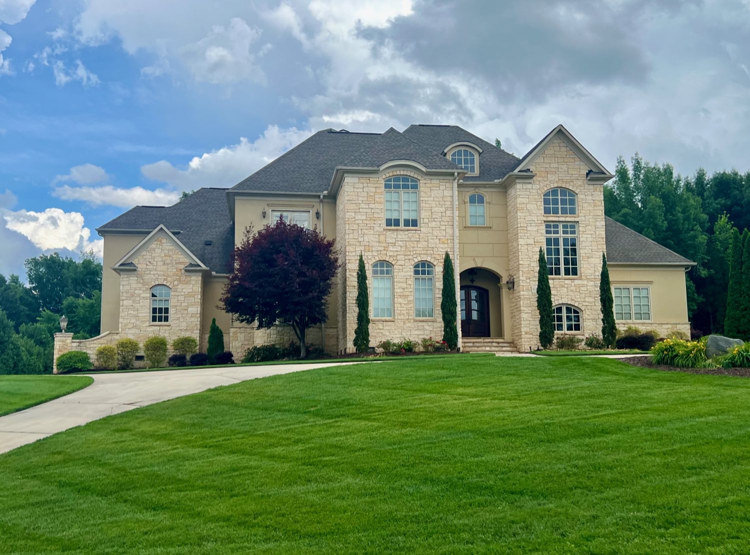 Cream brick French country chateau with arched windows